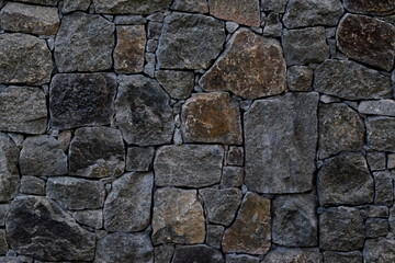 closeup detailed gray-brown stone wall texture background