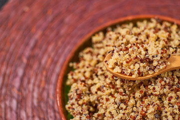 Quinoa cooked in a clay plate. Healthy vegan food concept.