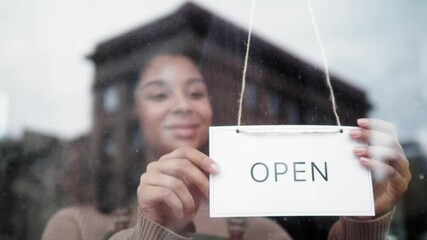 cafe or restaurants and business reopen after coronavirus quarantine is over. woman with face mask turning a sign on a door shop. small business after covid lockdown. small business open sign. - Powered by Adobe