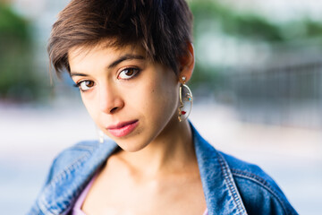 Hispanic young Tomboy bisexual woman headshot portrait. Short hair lesbian lifestyle 