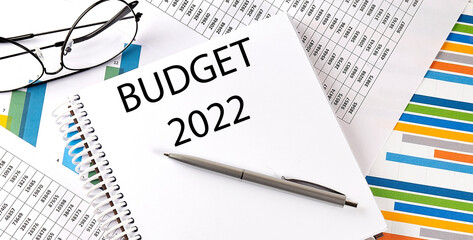 Notebook with text BUDGET 2022 . Diagram and white background,Business concept