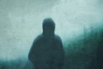 A moody lone hooded figure, back to camera, looking at a foggy hillside on a moody atmospheric day. With an abstract, grunge, edit.