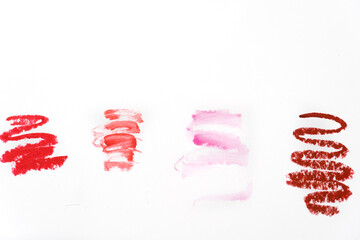 concept fashion flatlay of cosmetics swatches of beauty lipstick on white background
