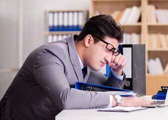 Tired businessman working in the office