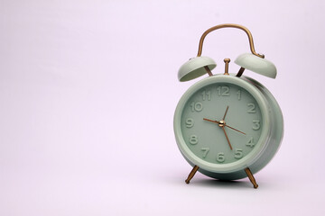 Retro alarm clock on white background.