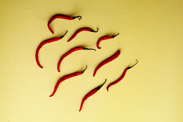 Red Hot Chili Peppers On yellow background. A Lot of Red Chilli Peppers. Flat lay, top view.