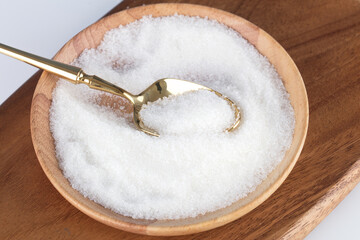 Sugar in a plate and a spoon