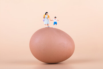 Mother holding son's hand on the egg