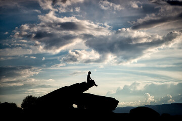 silhouette of a girl on the top of mountain