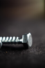 Close-up photo of a fastener on a black surface