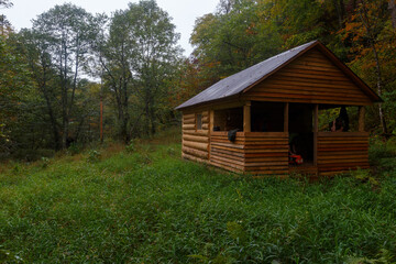 Sikhote-Alin Biosphere Reserve. Far Eastern autumn taiga. Wooden hut in a dense forest. Hunting...