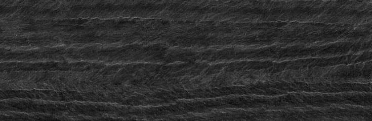 Panorama dark gray stone background with copy space. Black grunge banner with rock texture.