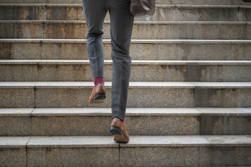 close up legs of businessman walking stepping up stair in the city. successful,grow up concept