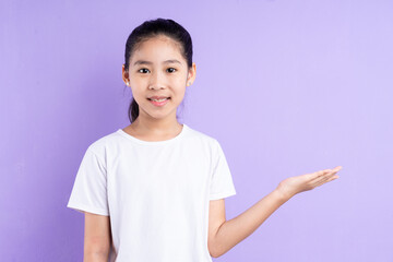 Portrait of Asian child on purple background
