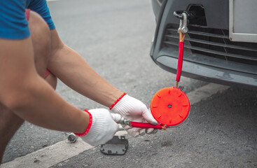 Hand holding yellow car towing strap with car, car towing, towing rope,copy space for text.