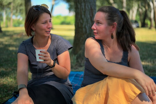 Two mature women having picnic in park