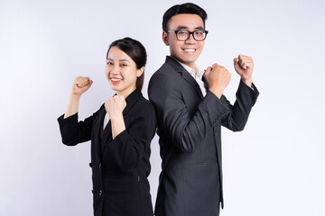 Asian businessman and businesswoman posing on white background