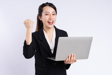 Young Asian businesswoman using laptop on white background