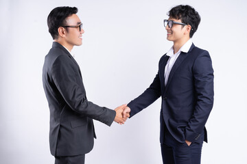 Two Asian business men shaking hands on a white background