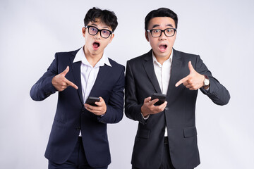 Two Asian businessmen using smartphone on white background