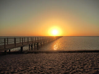 Bright sunrise with large yellow sun in Arabian Gulf