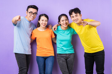 Asian best friends posing on purple background