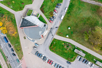 outdoor parking lot with parked cars. aerial drone photo looking down