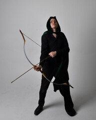 Full length portrait of a  brunette man wearing black shirt, waistcoat and a green velvet cloak...