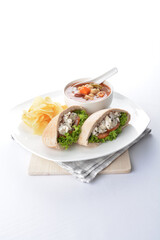 chicken salad kebab open pocket bread serve with tomato soup and crispy potato chips combo set  in white background asian vegan halal menu