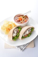 chicken salad kebab open pocket bread serve with tomato soup and crispy potato chips combo set  in white background asian vegan halal menu