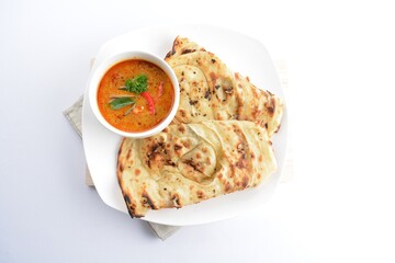 indian roti prata canai 2 pieces with spicy curry chicken gravy soup in bowl in white background asian halal menu