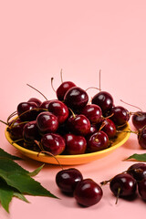Fresh sweet cherries on pink background.