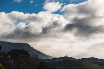 Fototapeta premium thick clouds over the hills and mountains of Tasmania, Australia