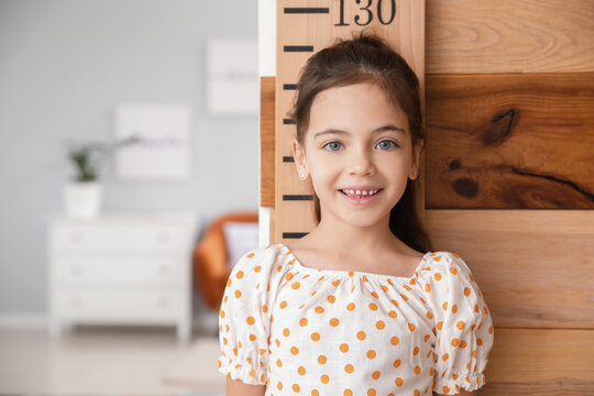 Little girl measuring height at home