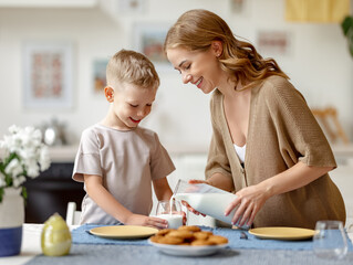 Mother pouring milk for son