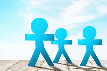 Blue people paper standing with a blue sky background