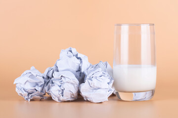 White paper ball and half a cup of high calcium milk