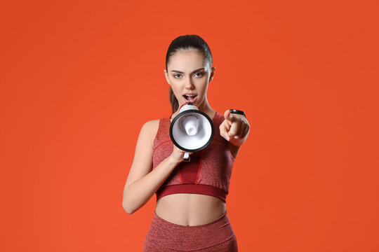 Sporty female coach with megaphone on color background