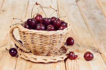 Fototapeta na wymiar Fresh juicy cherry fruits in a wicker vase.