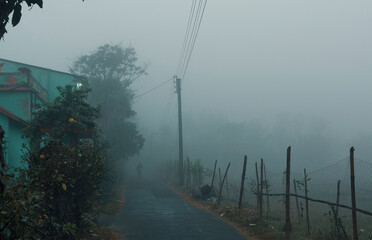 A rural village covered in thick, dense fog during a winter morning. Shot taken at Fraserganj, West...