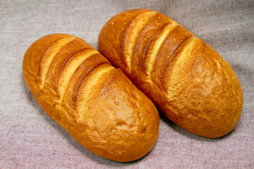 Two fresh loaves of bread with a golden crust.