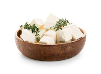 Wooden bowl with pieces of feta cheese and thyme on white background