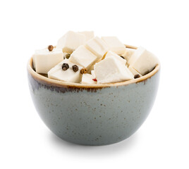 Bowl with pieces of feta cheese and peppercorn on white background