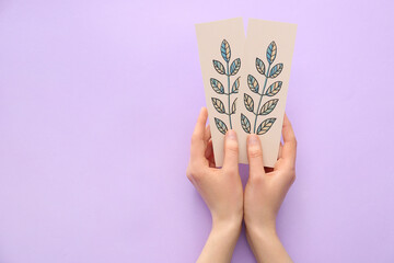 Woman with bookmark on color background - obrazy, fototapety, plakaty