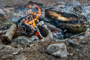 burning log of wood close-up as abstract background, the hot embers of burning wood log fire