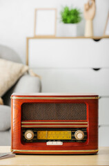 Retro radio receiver on table in living room