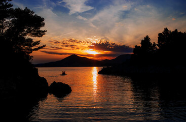 Fototapeta na wymiar Beautiful boat on a background of mountains, sunset over the sea