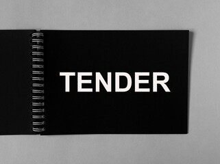 Business tender inscription on black paper on gray background