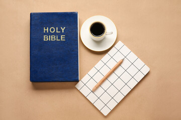 Holy Bible, cup of coffee and notebook on color background