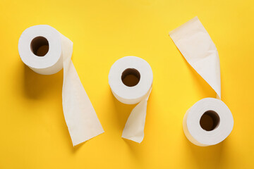 Rolls of toilet paper on color background